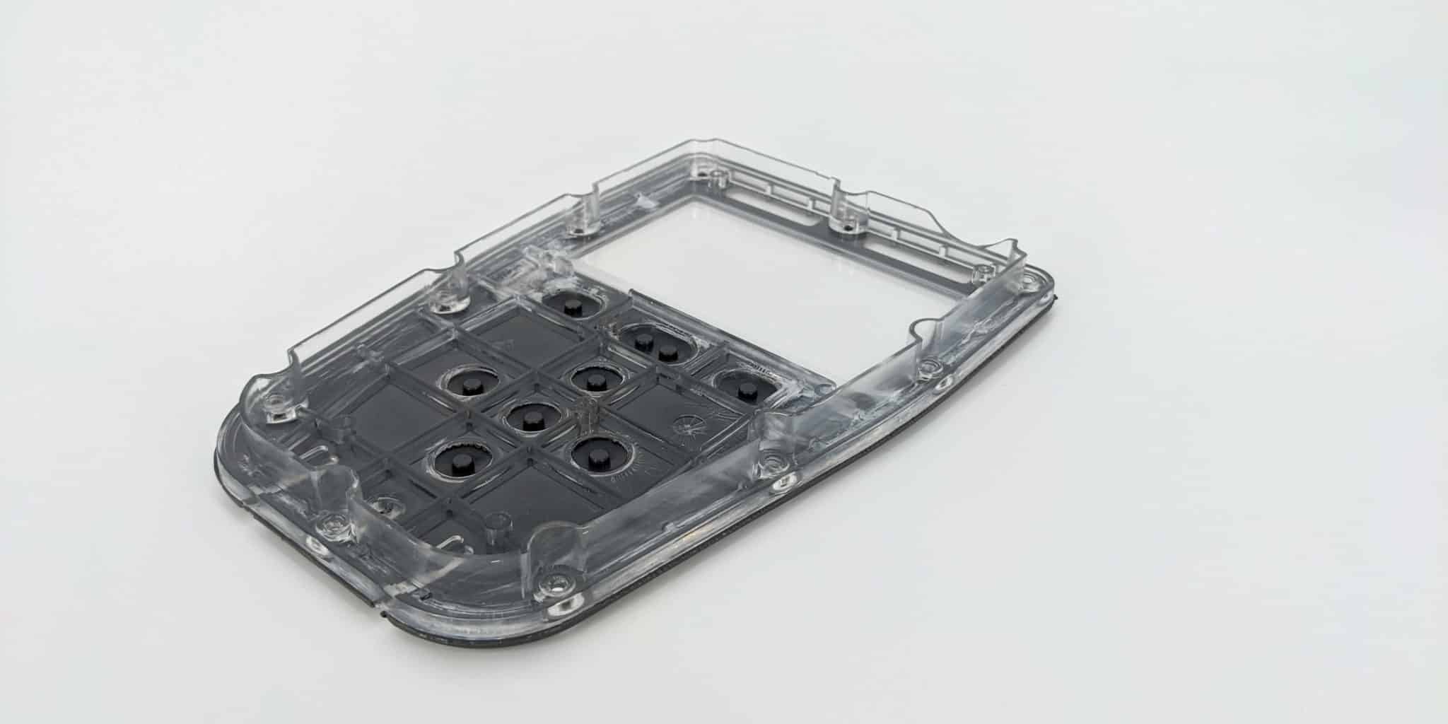 Overmoulded case for electronics with PCB buttons.